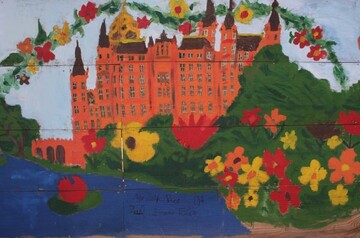 Das Schloss, der See und die Blumen - das Bild einer Schulklasse an einem Schweriner Bauzaun zeigt, was die BUGA 2009 auszeichnet.
