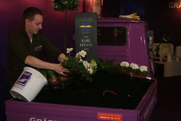 Christian Walz aus Stuttgart pflanzte live auf der IPM in Essen ein Mustergrab auf die Lade-flche des Grber bewegen-Mobils. 